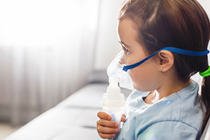Child With Asthma With a Respirator Mask